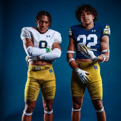 Eli Bowen is posing with his hands folded whereas, Peyton Bowen is showing four fingers.